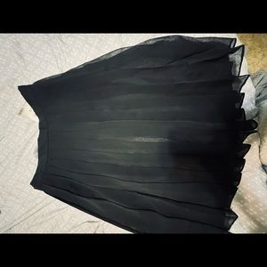 Woman’s pleated black skirt